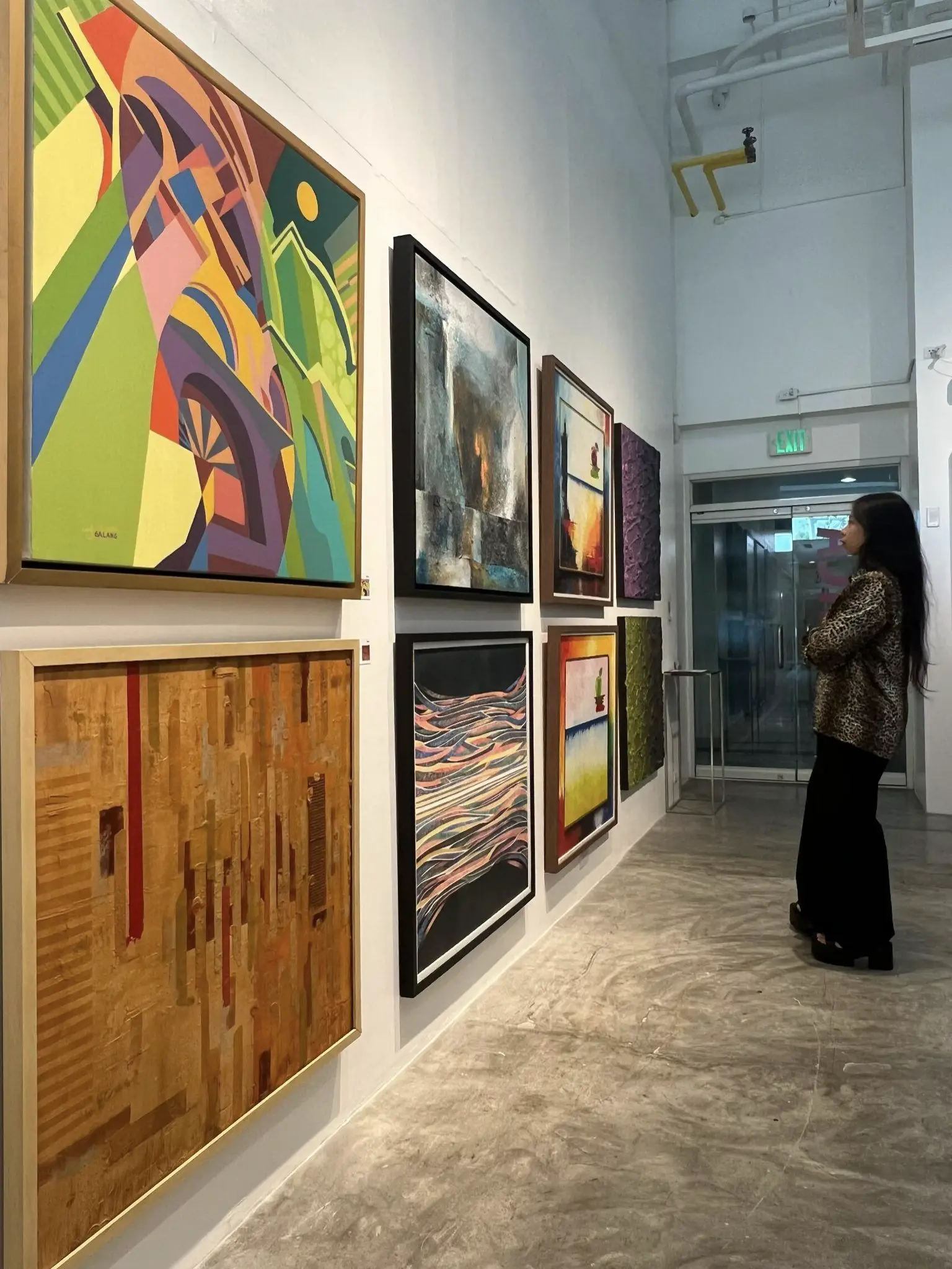 A guest admiring the artworks from “Brainstorm 3”, a recent exhibition at Imahica.