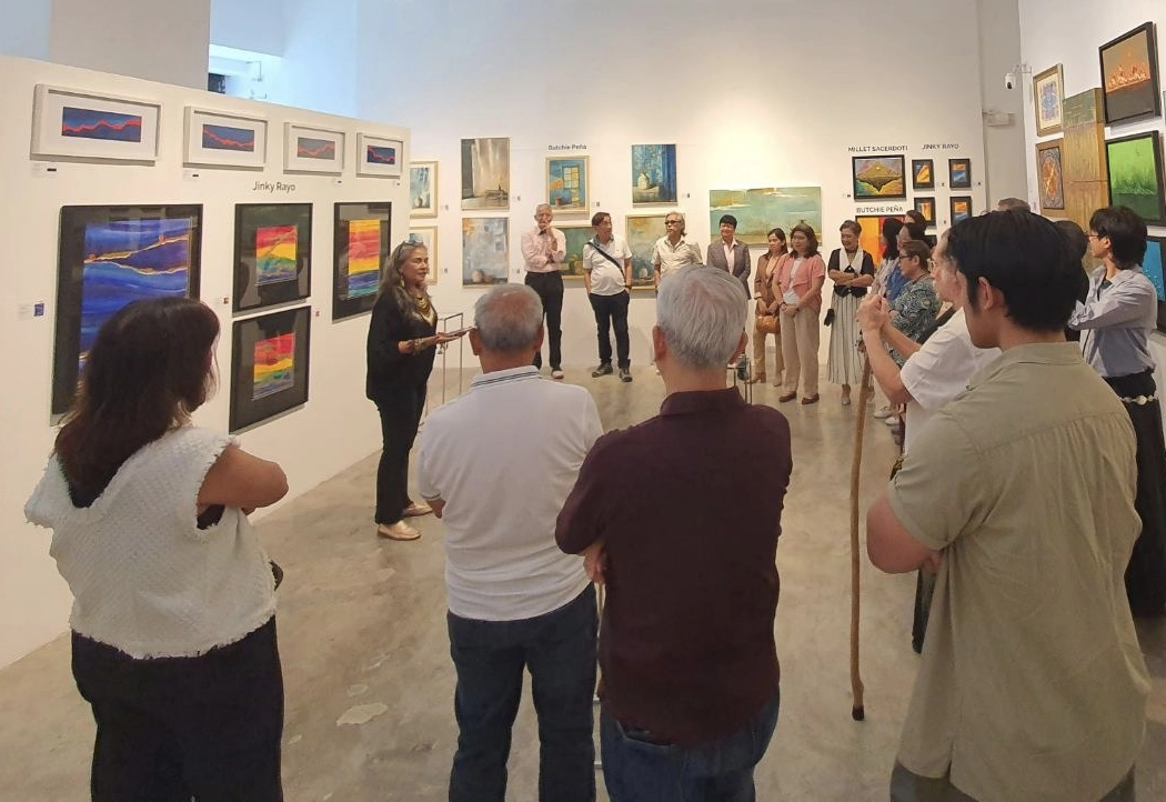 Artist Jinky Rayo, gives a speech at the opening of “Triadico”